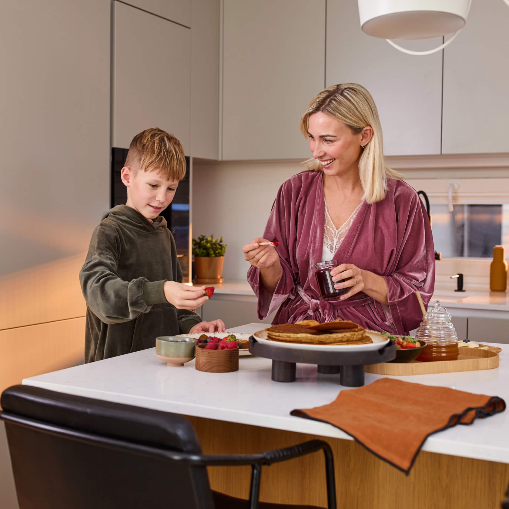 Parent and child enjoying breakfast in their new kitchen
